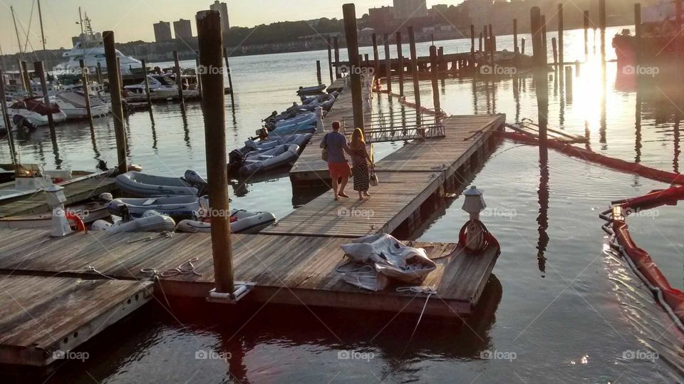 Young Couple Enjoying the Dock and the Sunset at the Hudson River NYC