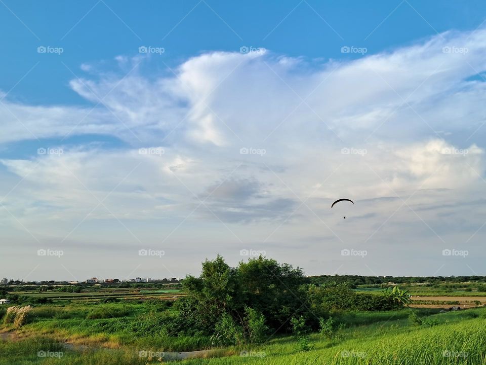 Paragliding in summer sky