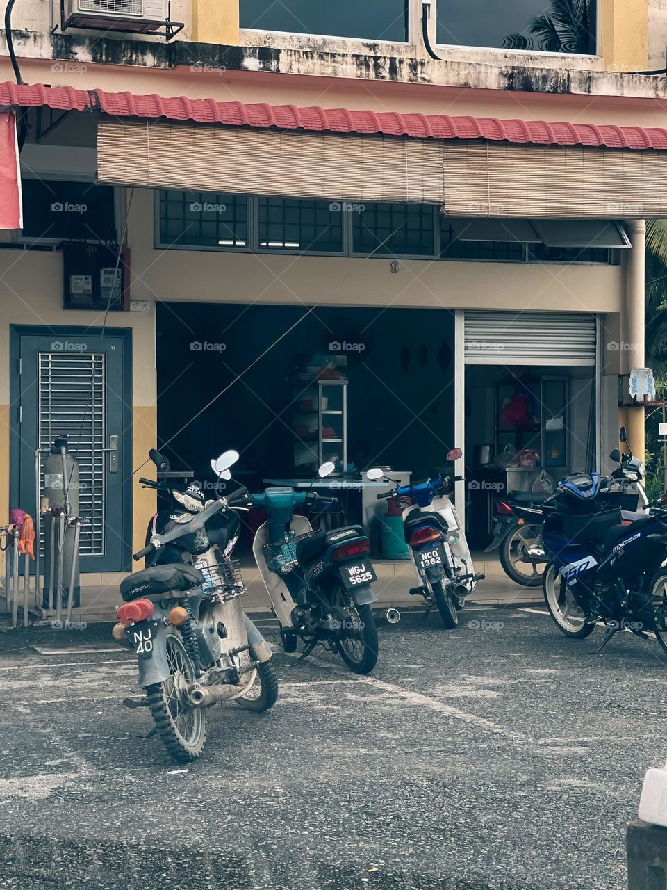 Some motorcycles parked outside a local shop in a small town