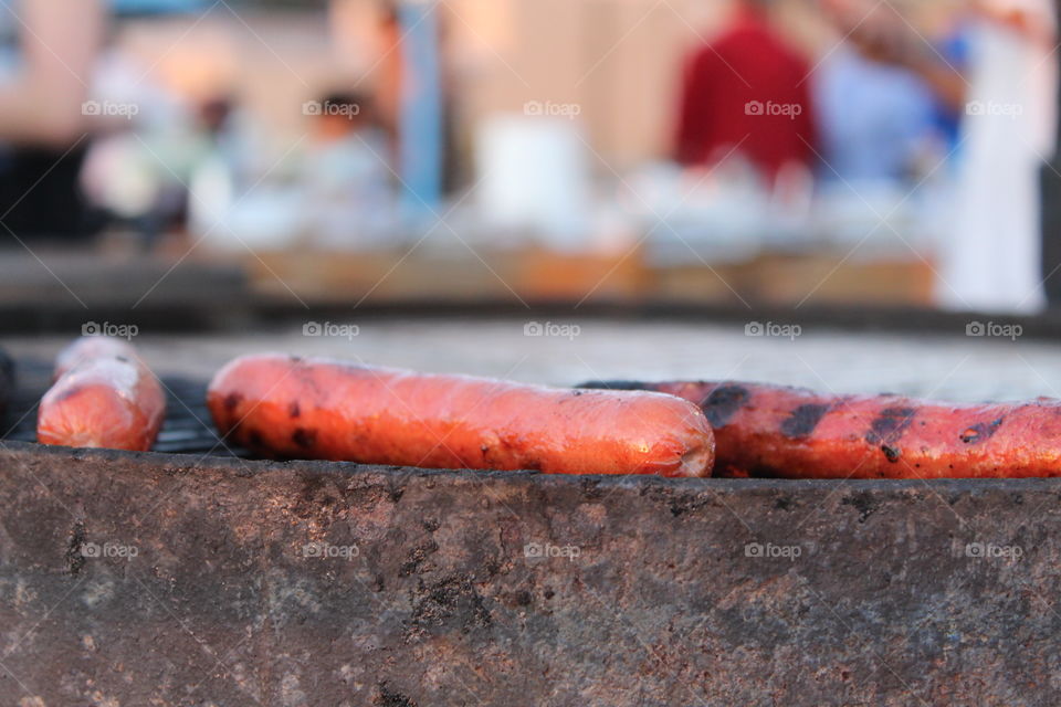 Close up of hot dogs on a grill