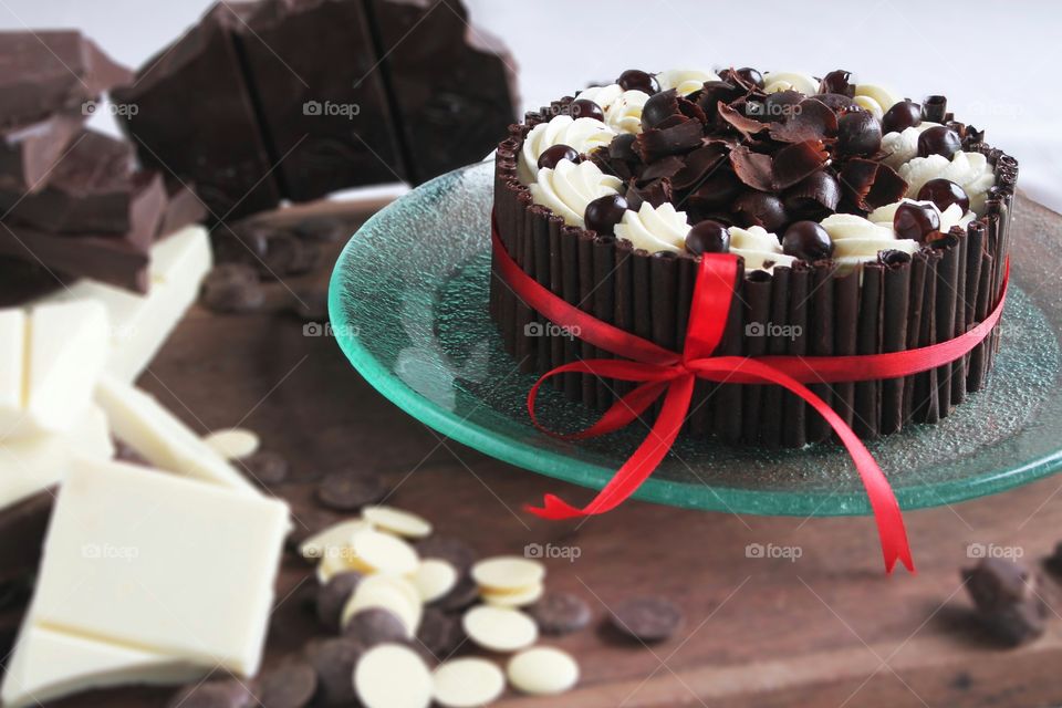 chocolate cake on wooden board with chocolate bar as garnish