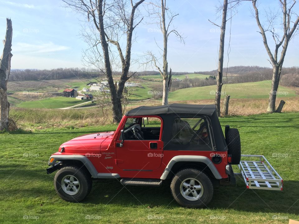 2000 red tj Jeep Wrangler out on a trail. 
