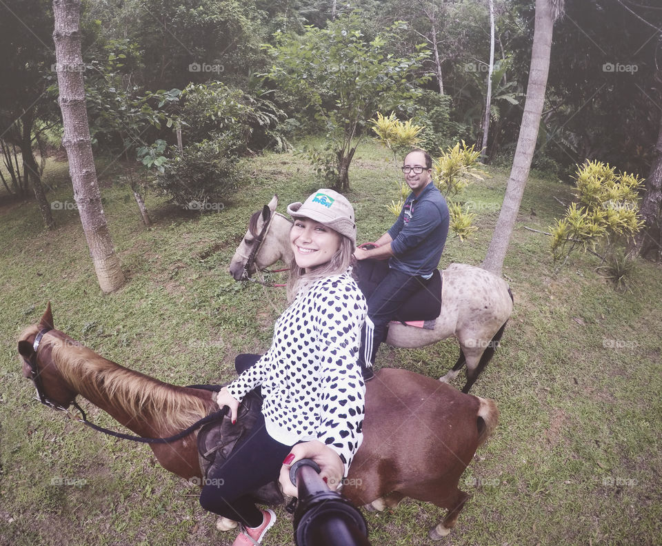 Father and daughter riding a horse 