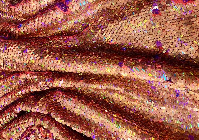 Pink sequins and gold metallic fabric background