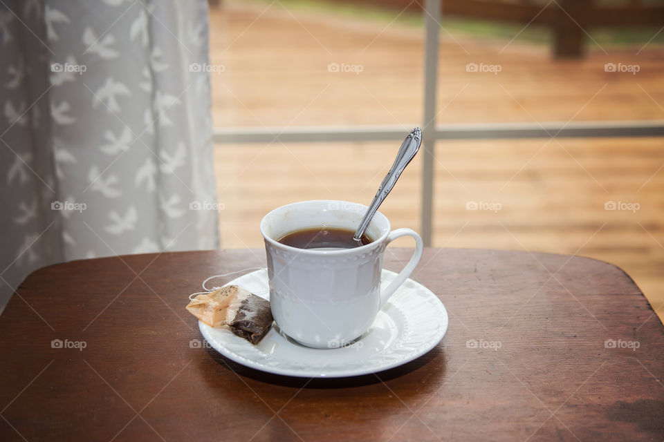 Tea cup with teabag on table