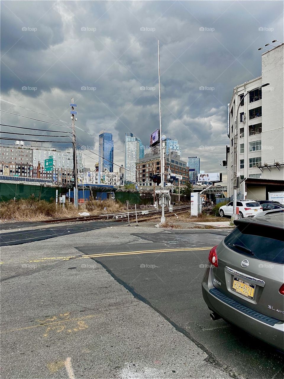 This is the “Long Island Railroad” crossing at “Borden Avenue” and “11th Street” by the “Pulaski Bridge” at “Newtown Creek” in LIC, Queens. 2023. Hypnotic Productions