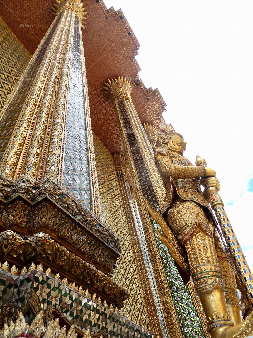A olden giant watches over the Temple of the Emerald Buddha