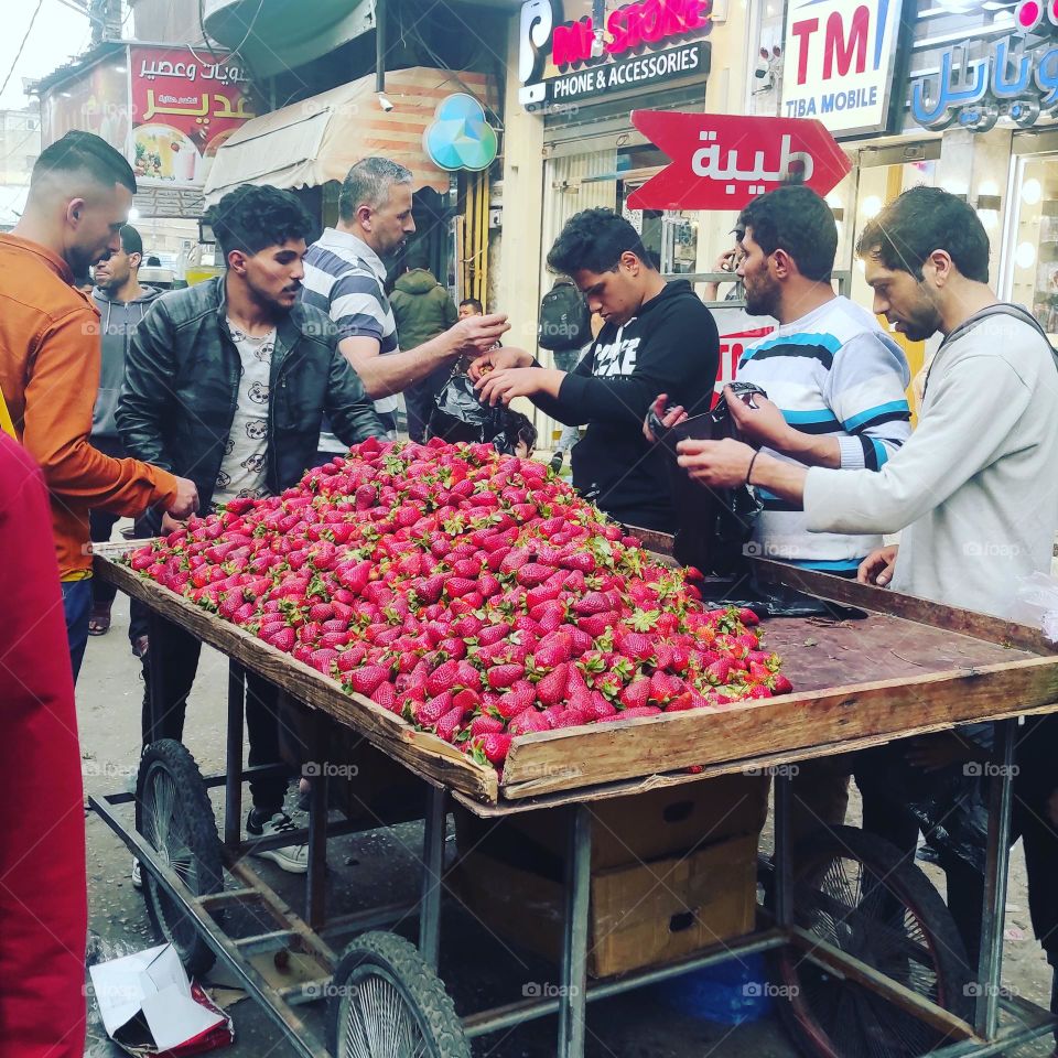 This picture is of some people buying berries