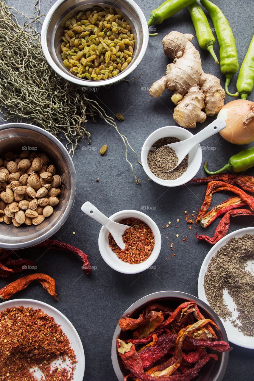 An array of different spices laid out on the table.