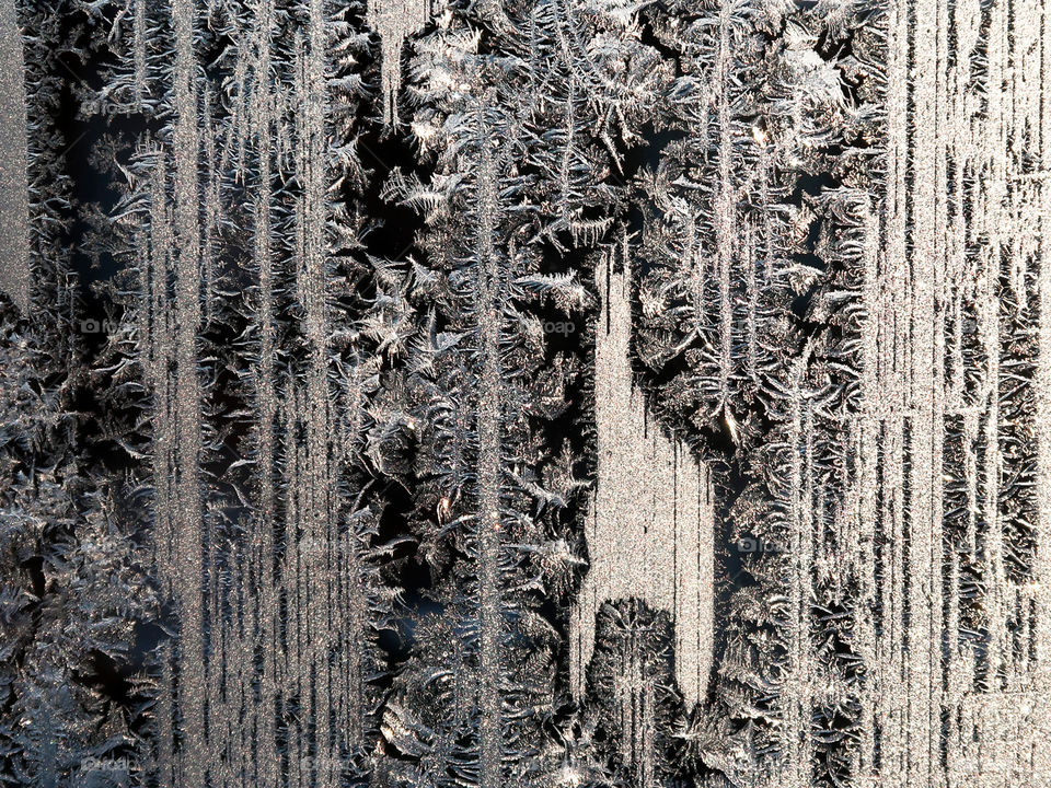 Frost patterns on a frozen window in December
