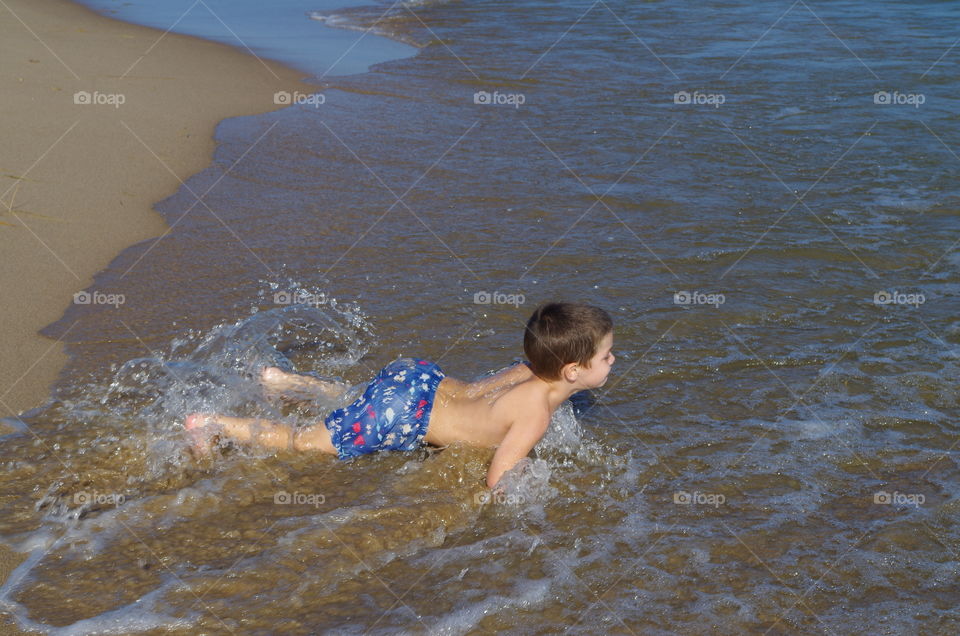 Boy swimming in sea