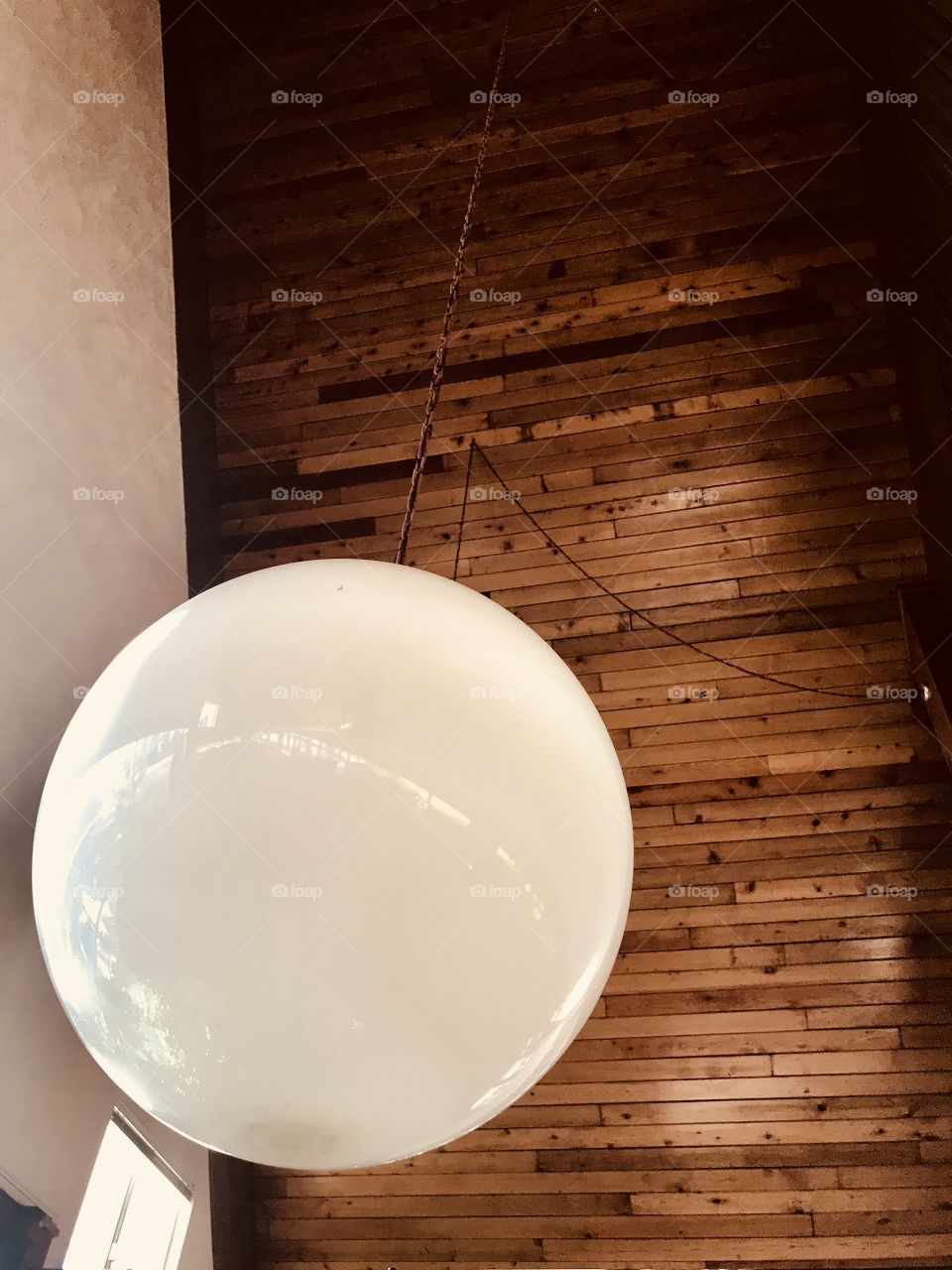 The beauty of interior design with the big light ball hanging and the beauty of the wood ceiling. 