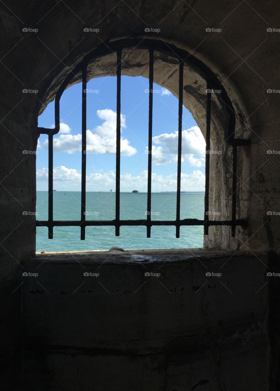 Barred window with sea view