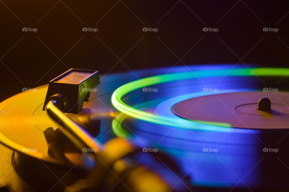 disk of an old loudspeaker in different colors, long exposure photo with light trails