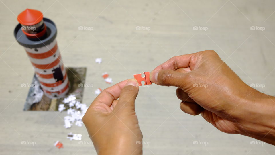 Person holding jigsaw puzzle