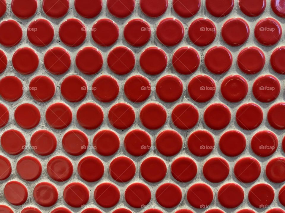 Red round tiles on the wall