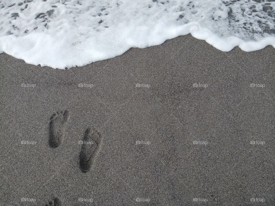 Footprints on sand at beach