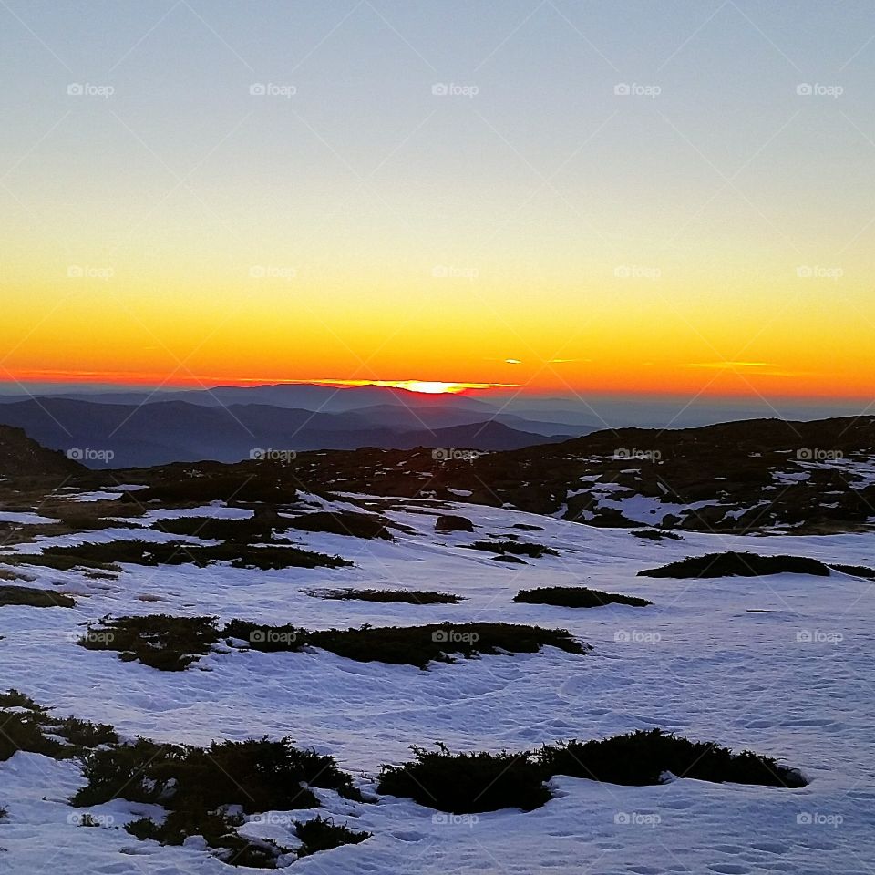 Sunset over mountain during winter