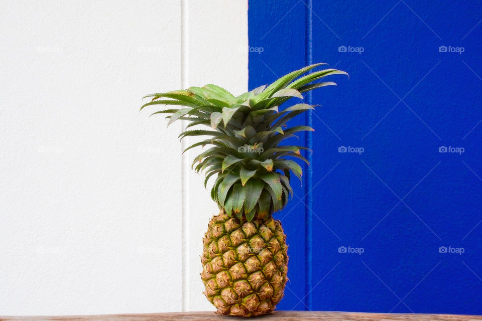 Isolated pineapple on white and blue background