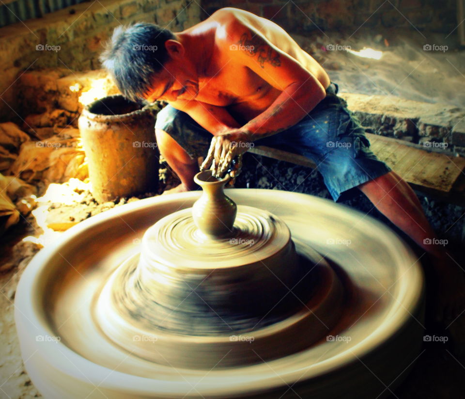 Pottery man making pot