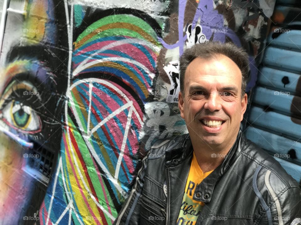 Self portrait against a graffiti background in Hosier Lane, Melbourne 