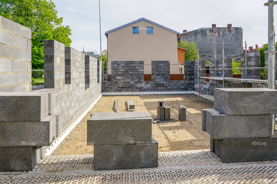 concrete foundation and wall construction of a new house, view of construction site in preparation proccess