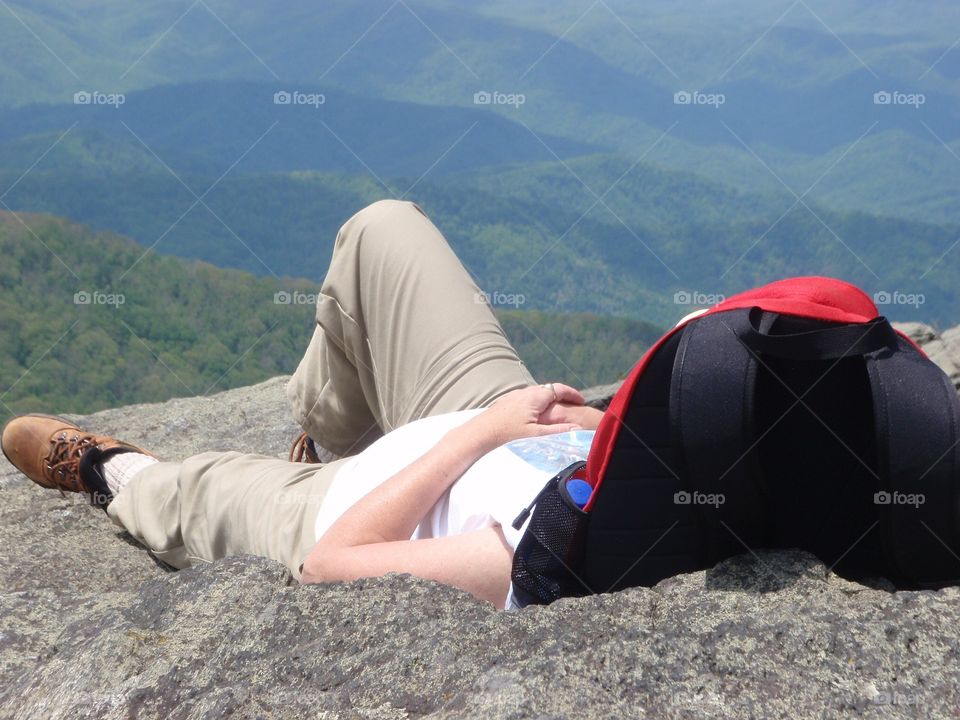Hiker relaxing on mountaintop