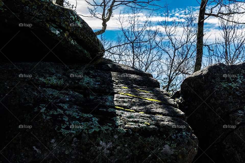 Peeking at blue sky over some boulders