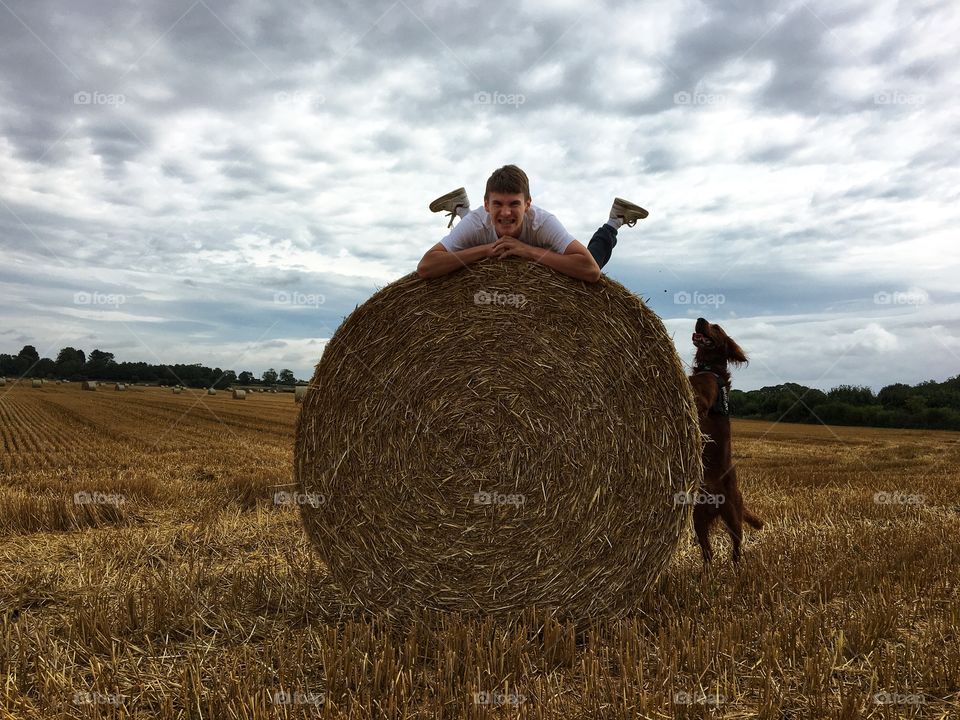 Fun Family Time ... my son climbing on top of a haystack pulling a funny face and the family dog Quinn trying to climb up too 💗