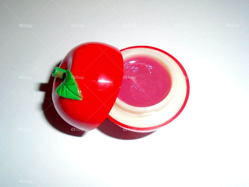 Lip balm in apple-shaped container