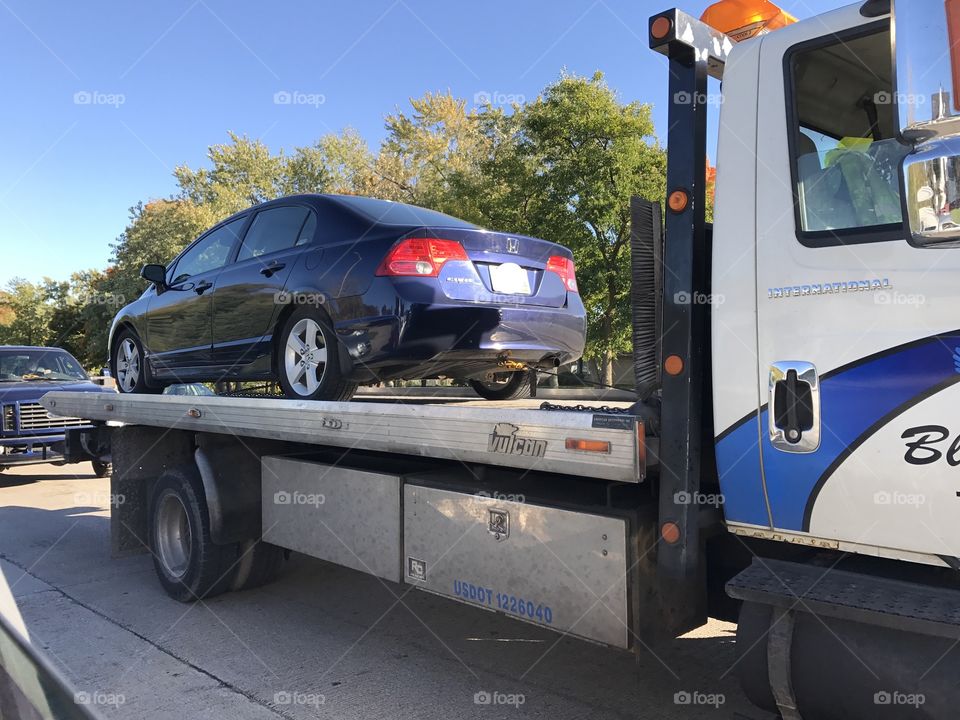 Tow truck towing a Honda Civic