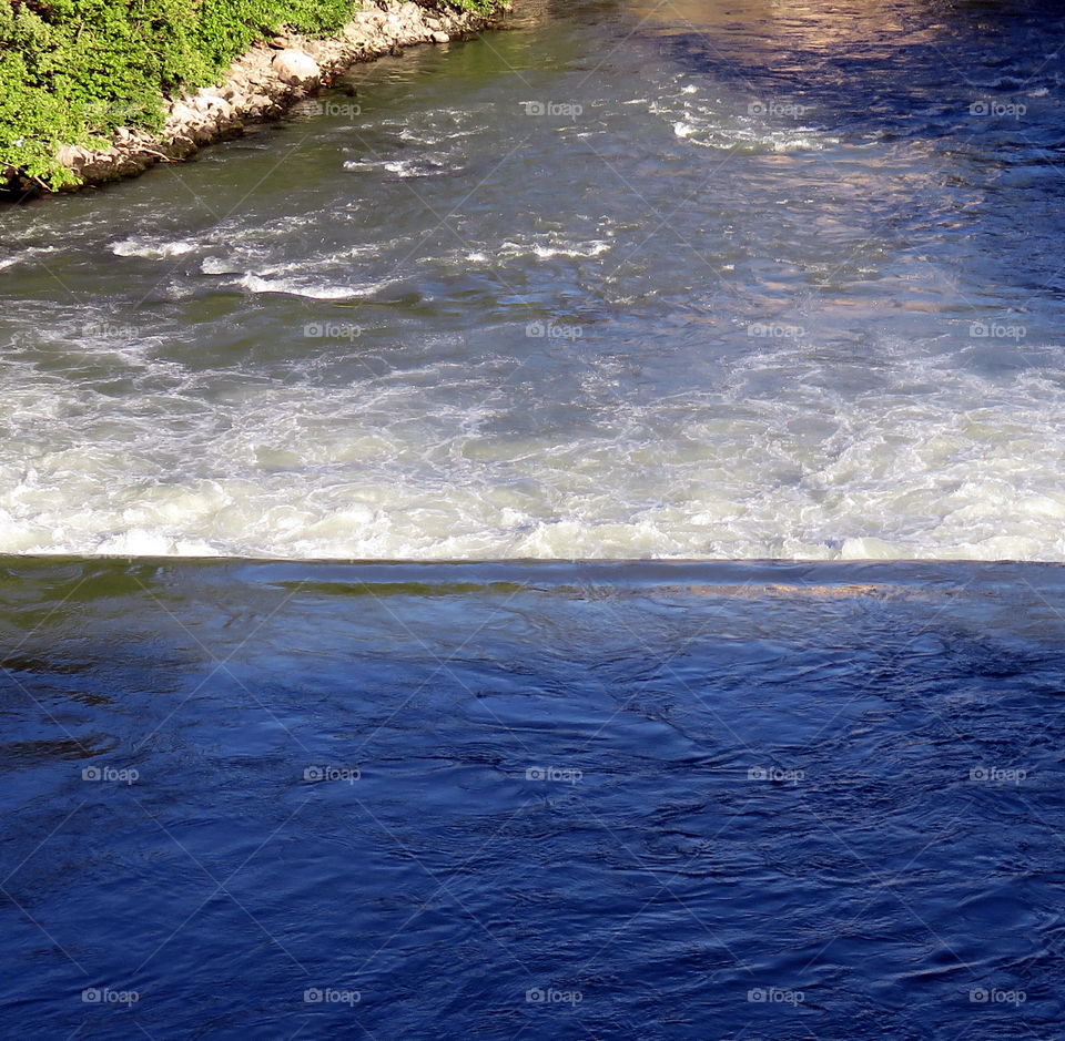 River waterfall with water rebound, waterfront and shadow