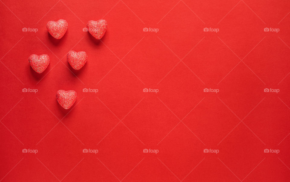 Red hearts on a red background. Valentine's Day. Postcard. Red pepper.