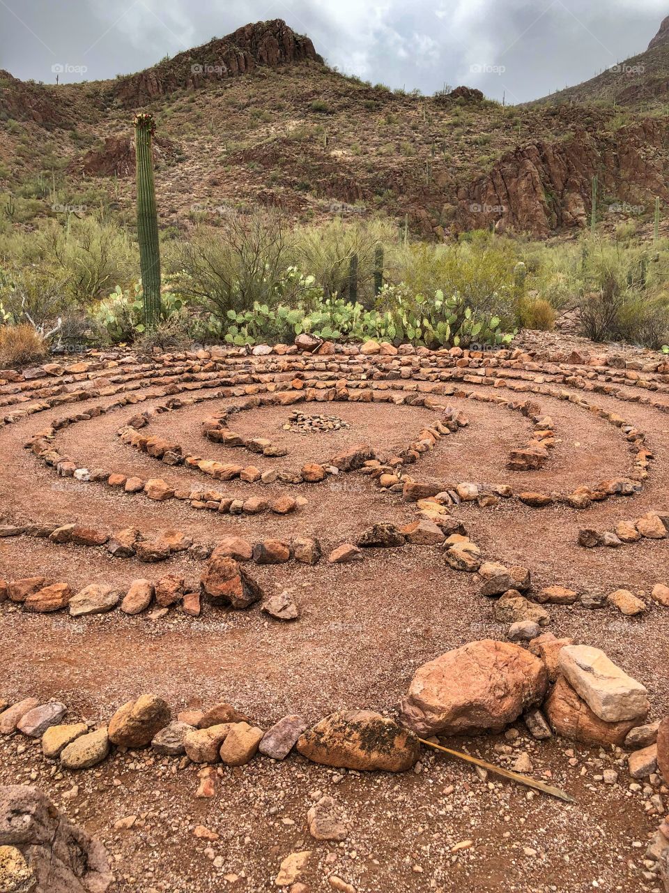 Labyrinth for personal meditation and retreat in the desert in front of mountain backdrop.