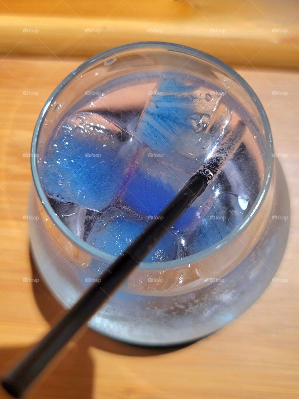 Rum cocktail with blue ice cubes