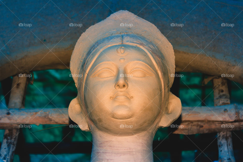 Handmade clay model of "Maa Durga" or " Devi Durga"- Hindu woman Idol close up. Snapped in the beginning of city famous Bengali festival of Kolkata or Calcutta, West Bengal, India, Asia
