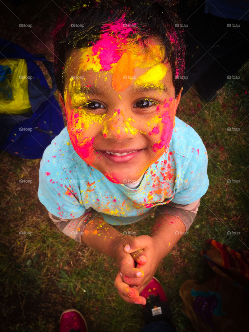Happy smiling kid with holi colors 
