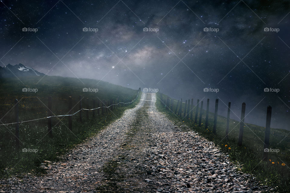Milky way above gravel path.