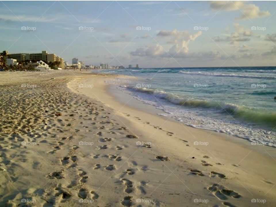 Beach at Cancun Mexico With footprints in sand along the shoreline 