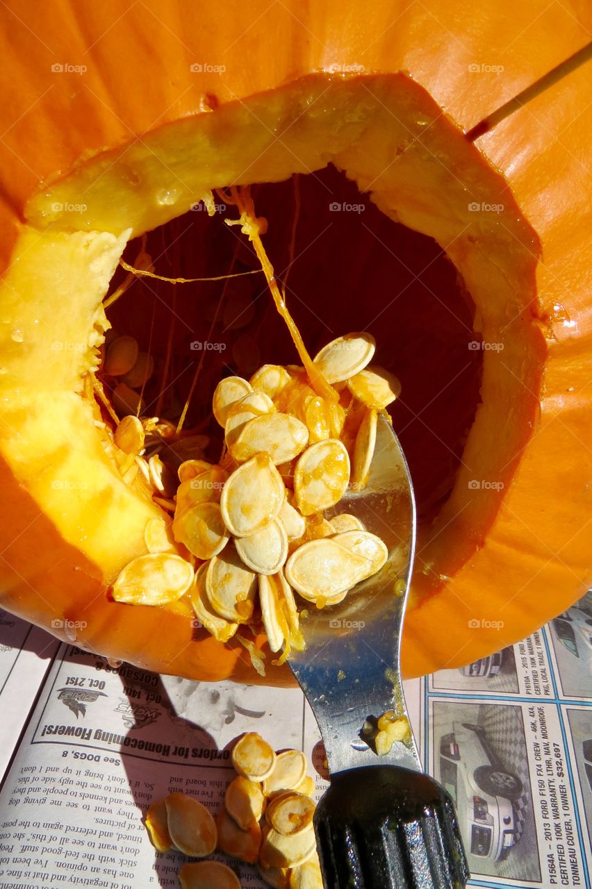 Turning a pumpkin into a Jack-a-lantern.