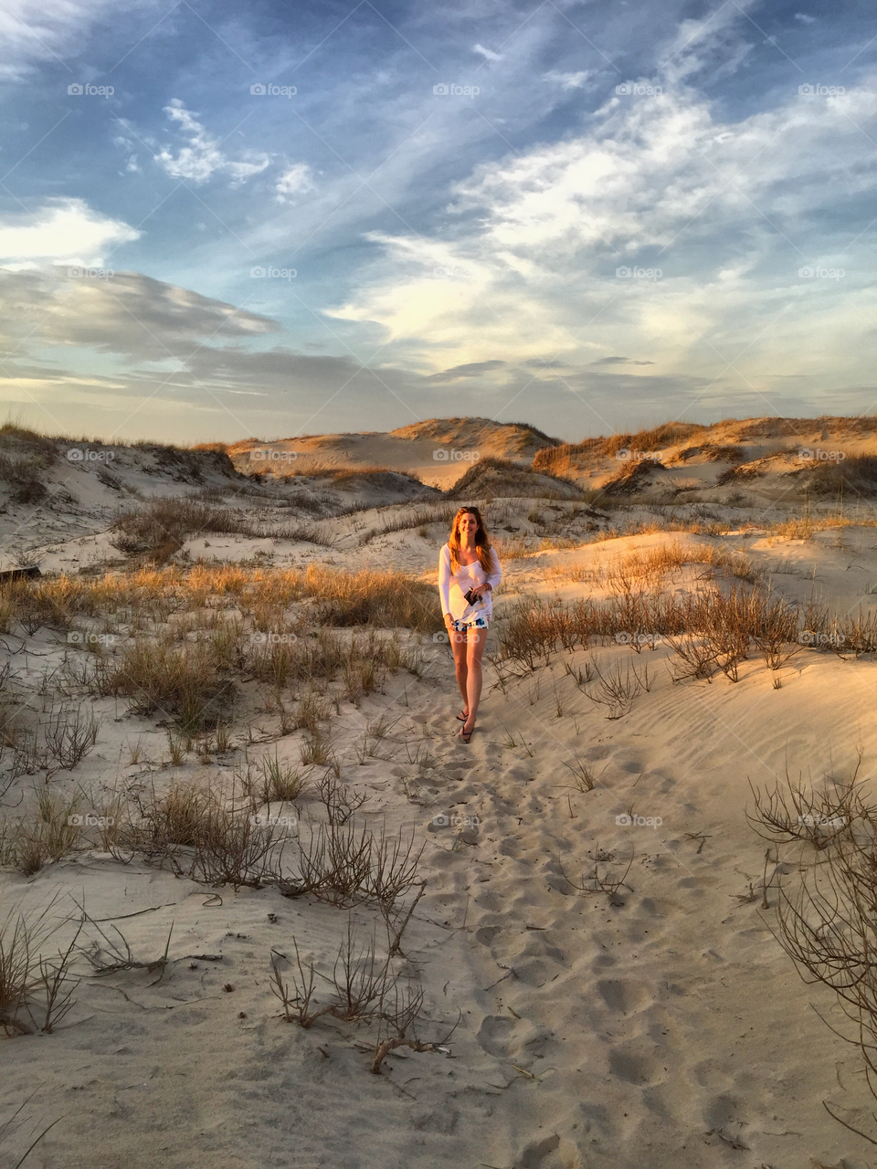 Woman walking in sand dunes