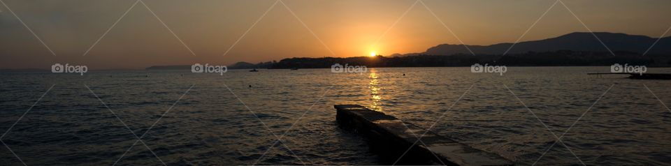 Sun setting over the Adriatic Sea in Podstrana, Croatia