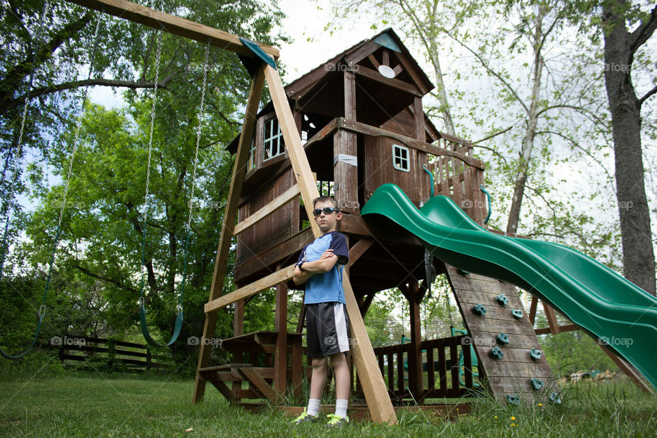 Boy standing in front of a swing set