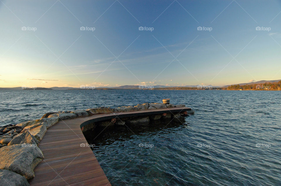 Serene lakeside dock with mountain views