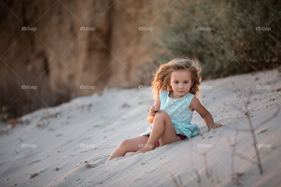 Little girl playing in the sand 