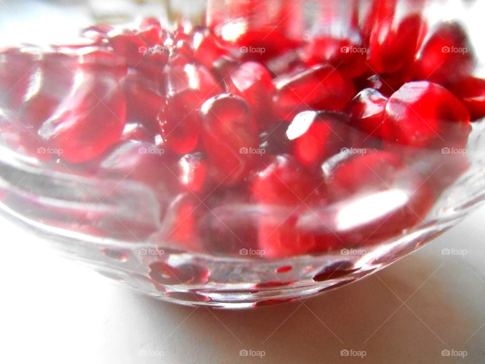 red pomegranate seeds healthy food white background