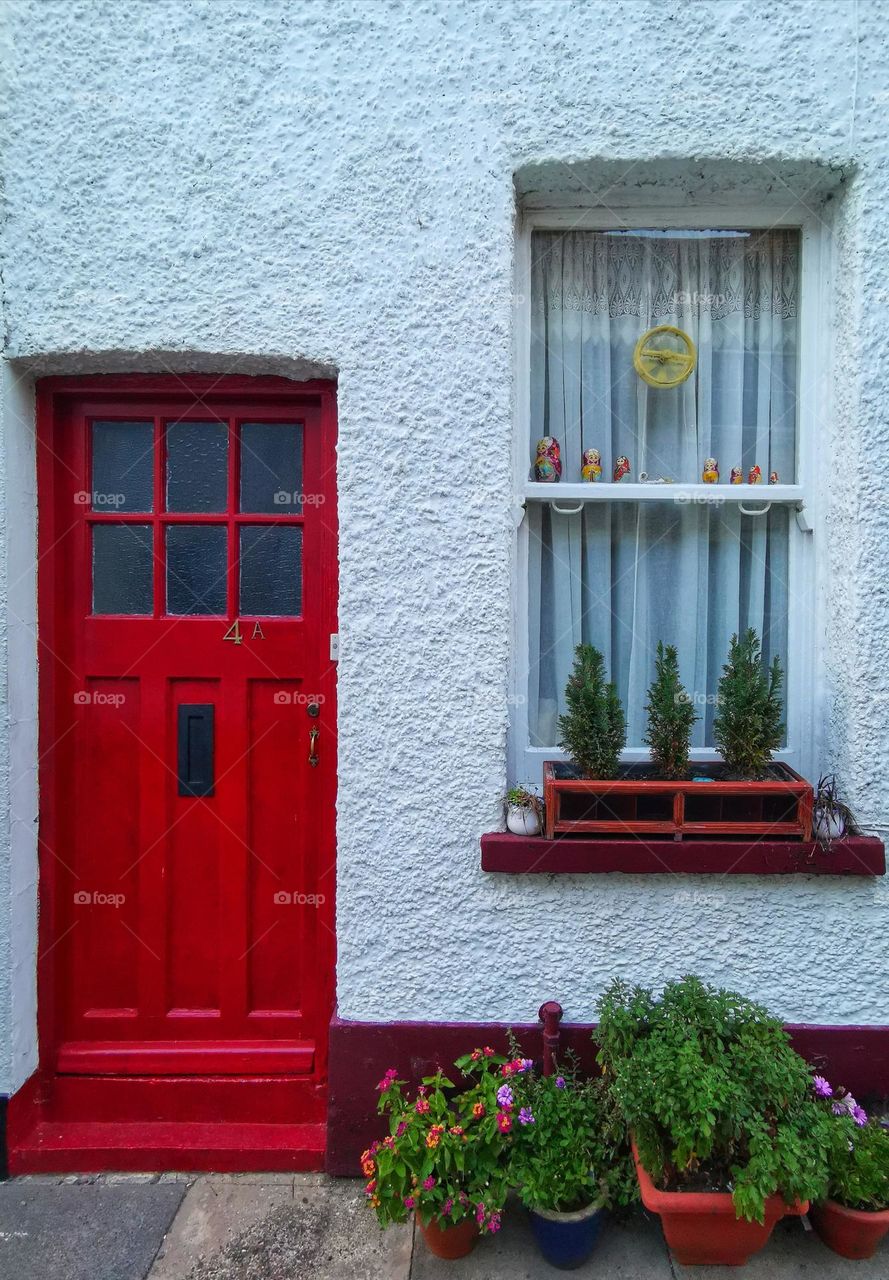 Red door and nice window. Architecture. Street photo.