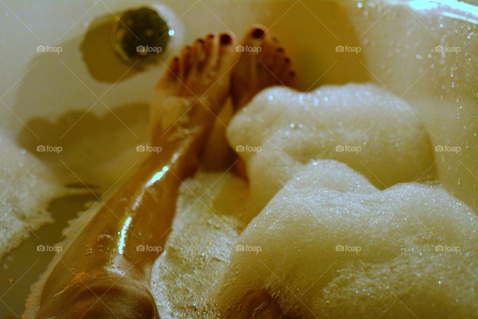 female legs barefoot relaxing in the bathroom