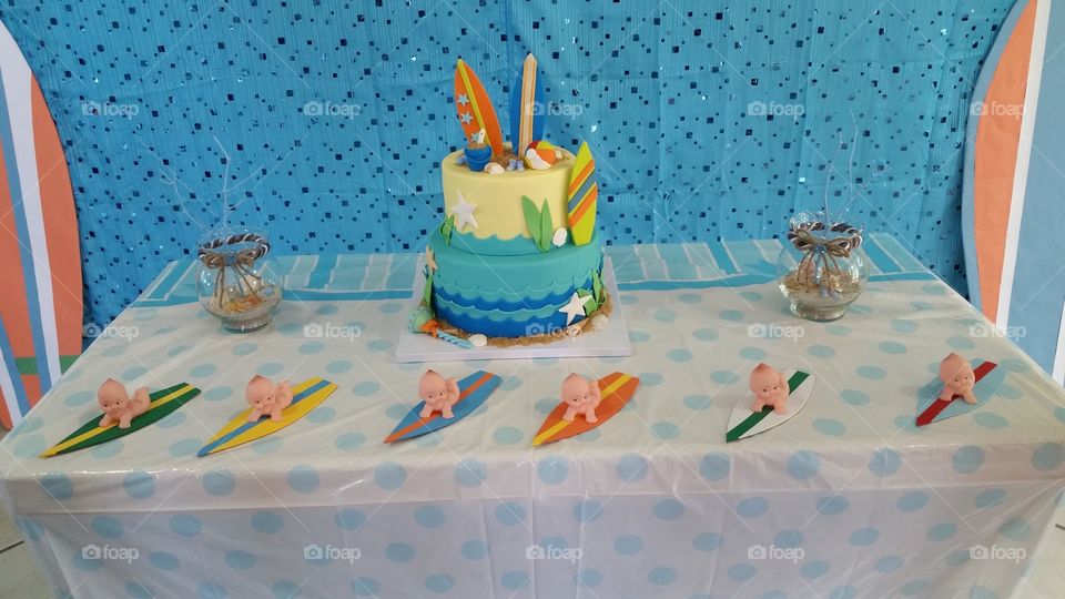 Baby shower cake table decorated with baby surfer theme