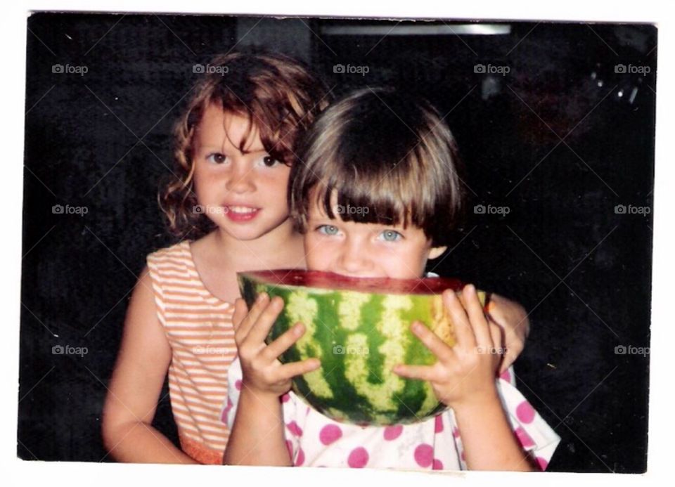 Girl with her sister eating watermelon